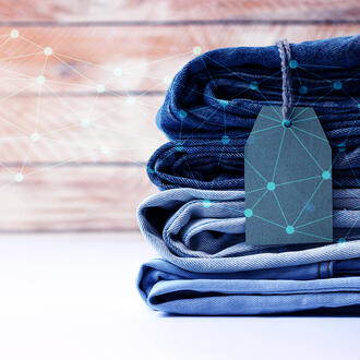 A stack of jeans with network/AI imagery overlayed on top