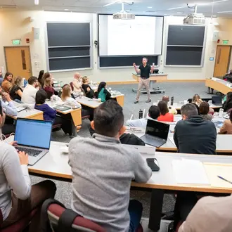 Professor Robert Gibbons teaching a full classroom