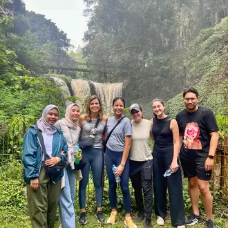 Photo of G-Lab team in front of a waterfall