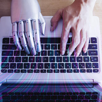 A robot hand and a human hand type on a keyboard