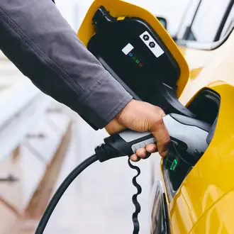 Hand plugging a charger in EV