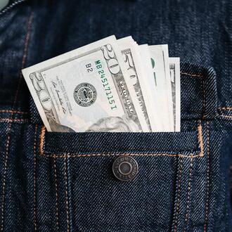 Image of a denim jacket's pocket, with money in it