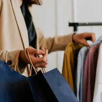 A customer peruses a rack of clothes