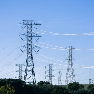 Electrical transmission towers and lines against a blue sky