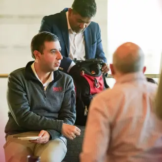 Three executive MBA students gather to converse