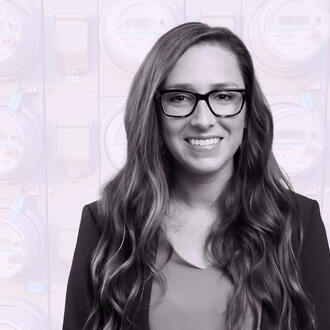 Jacqueline Pless amongst a background of digital electricity meters