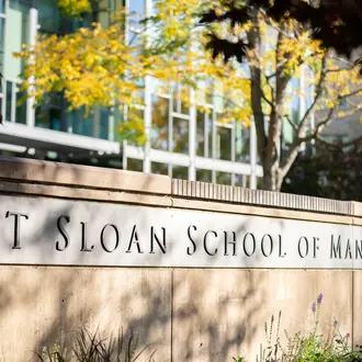 Inscription on wall outside of building E62 reading MIT Sloan School of Management