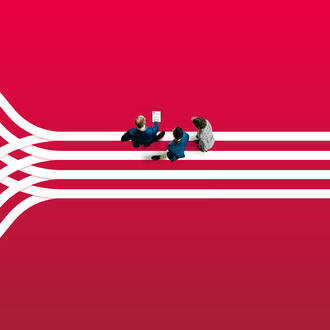 Three business workers look at a tablet with a connecting bars motif in the background