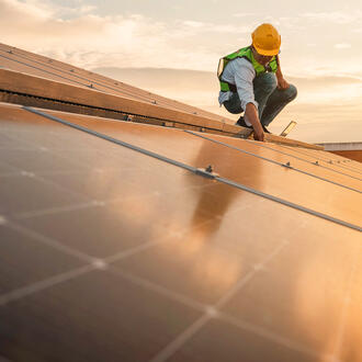 A person does work on a solar roof