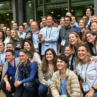 A large group of people poses for a photo off camera