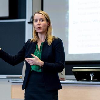 Bethany Patten speaking in a classroom.