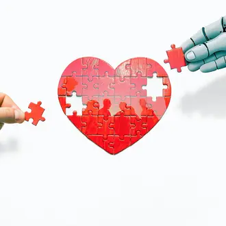 A robot hand and a human hand work on a heart puzzle with the silhouette of people inside