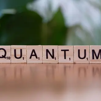 Scrabble pieces spell out the word "Quantum"