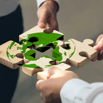 hands assembling climate jigsaw puzzle