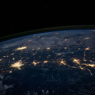 space level view of the earth, lights of major cities visible 