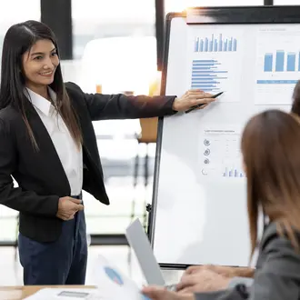 Confident business woman standing in front of her company, presenting her project and ideas on a board.