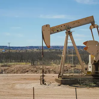 A Gray Steel Pumpjack Under Blue Sky