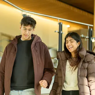 Two people talking while walking down stairs