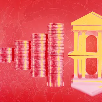 A reflection of stacking coins and a financial building in red and yellow