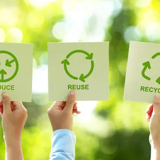 People holding recycling signs