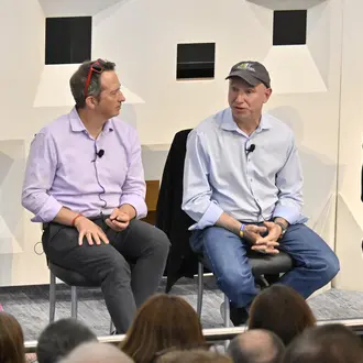 Panel of four people discuss topics onstage