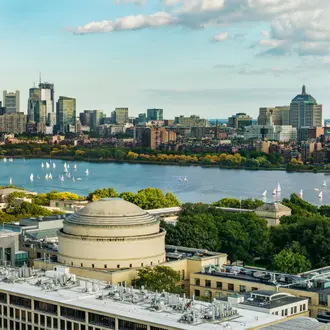 Aerial view of Boston across the Charles River with the MIT Great Dome in the foreground.