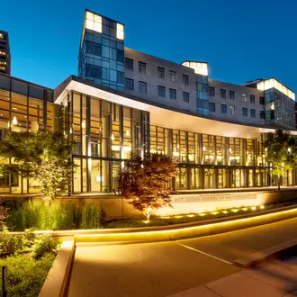 River side of MIT Sloan Building E62 at dusk