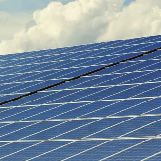 Image of Solar Panels with Clouds in the Background