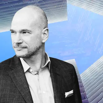 Andrew McAfee and buildings forming an arrow with code
