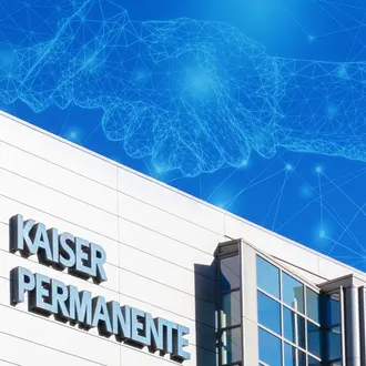 The Kaiser Permanente building with an abstract AI/digital image of a handshake in the sky