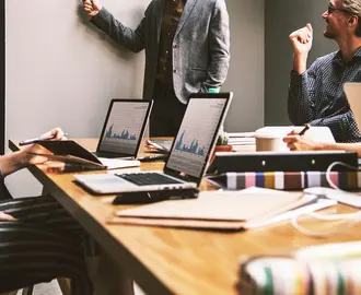 People discussing graphs in meeting