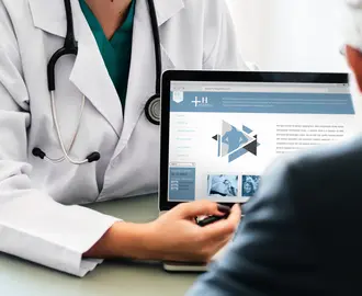 Doctor showing person a laptop screen