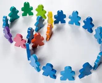 Multicolored wooden people illustrating a business concept - networking or teamwork.