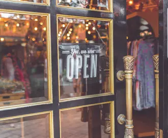 Open sign on clothing store.