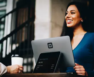 Woman smiling standing behind screen.