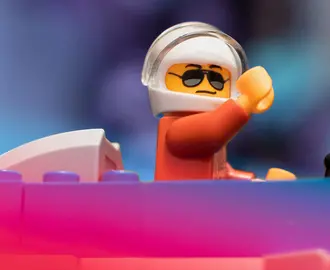 LEGO toy fighter pilot with his arm raised 