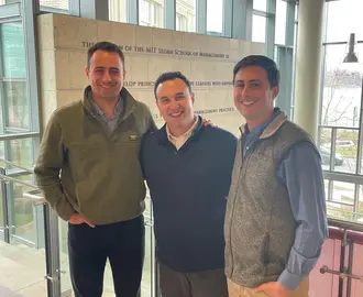 Eric Wainman, Jacob Alchek, and Connor Kozin in the MIT Sloan E62 building