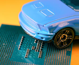 A toy car sits on top of a microchip