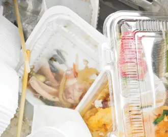 A black trash bag full of food containers