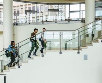 MFin students walking up stairs