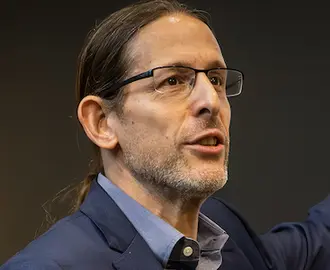 Man motioning towards slide on projector