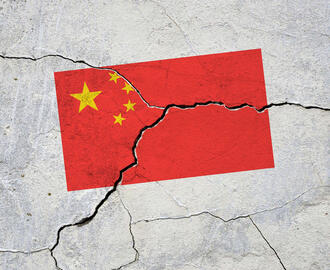 China's flag appears on a cracked cement wall