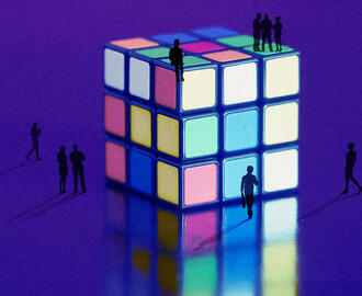 An illustration of people walking around a larger than life rubik cube