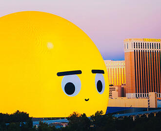 Las Vegas skyline with Sphere depicting giant emoji in foreground