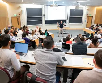 Professor Robert Gibbons teaching a full classroom