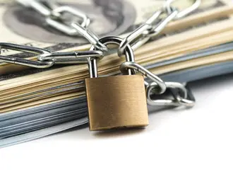 A heap of money  chained up with a locak