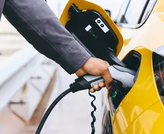 Hand plugging a charger in EV