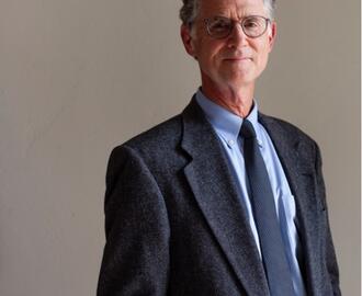 photo of Peter R. Fisher (white man with gray hair and glasses wearing a business suit)