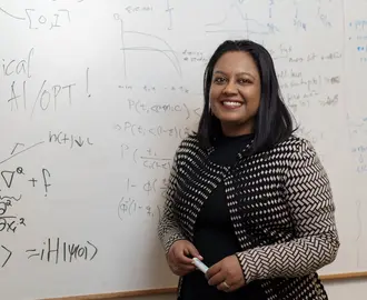 Professor Swati Gupta at a whiteboard