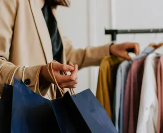 A customer peruses a rack of clothes